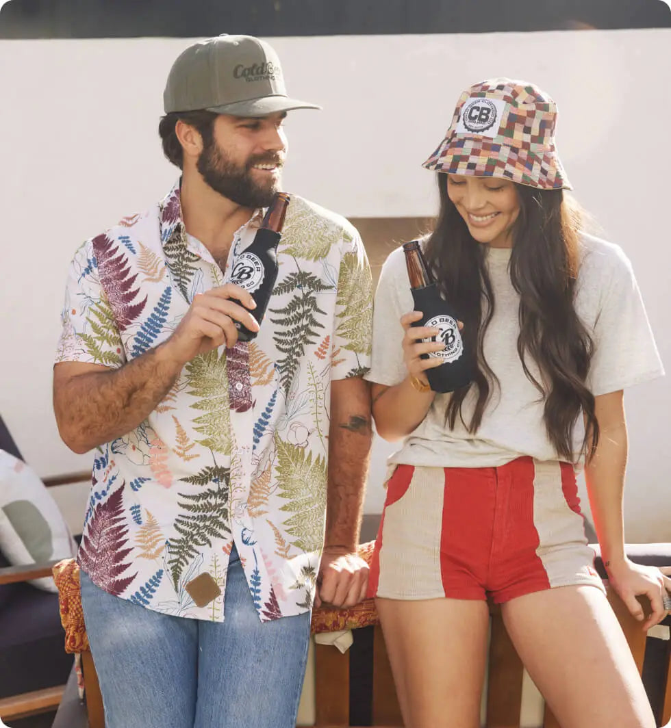 A man and woman wearing beer gear, enjoying a cold drink while dressed in stylish, casual apparel.