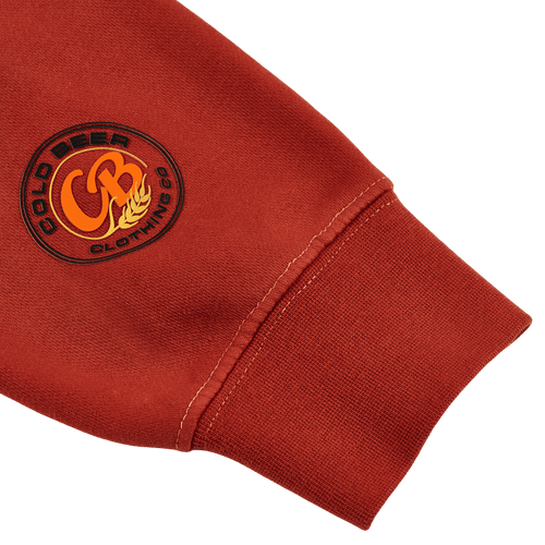 Close-up of the logo on the amber pigment-dyed crewneck