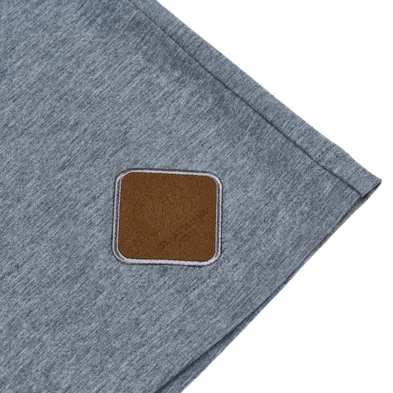 Close-up of the signature Gripp-Tac bottle-opening patch sewn near the bottom hem of The Fully Stocked Long Sleeve Tee by Cold Beer Clothing Co.