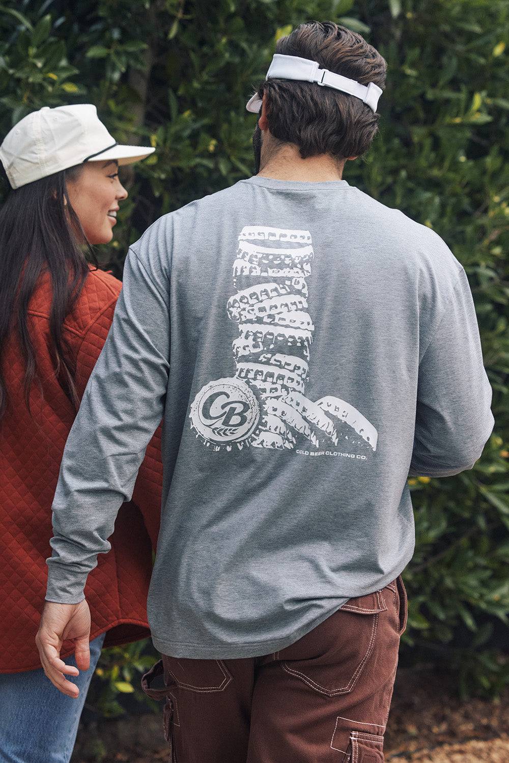 Man wearing The Fully Stocked Long Sleeve Tee by Cold Beer Clothing 
Co. in heather gray, featuring the large white stacked bottle cap graphic on the back.