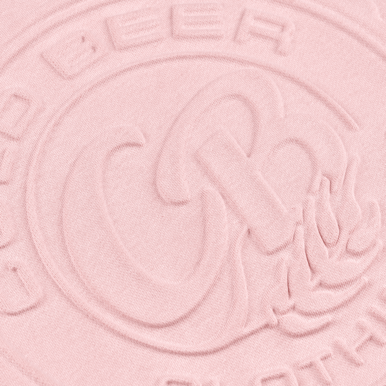 Close-up of the tonal 3D embossed Cold Beer Clothing Co. bottle cap logo on the Pink Crewneck Sweatshirt, highlighting the raised design and fabric texture.