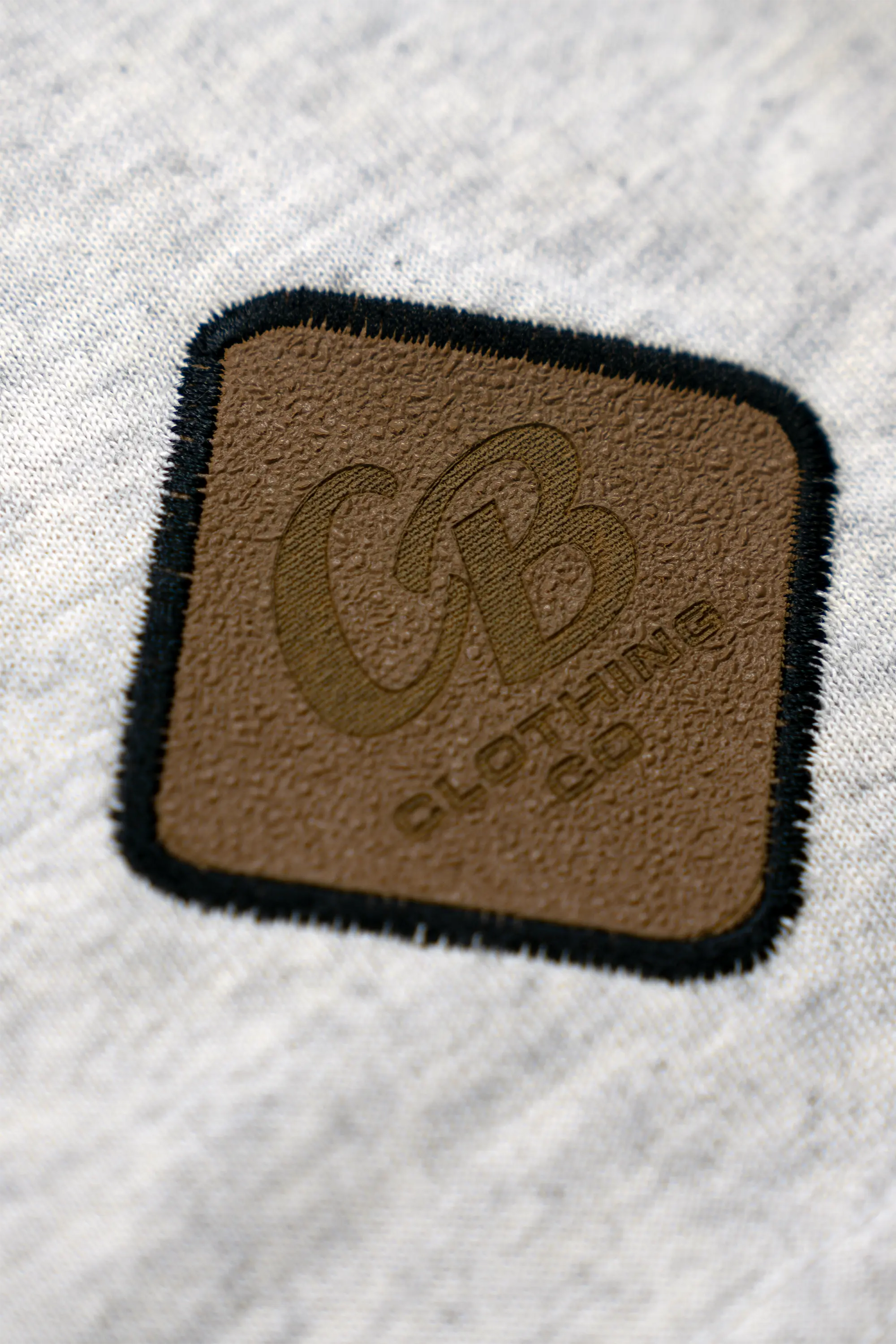 Script Logo Tee Up Close View Of Gripp-Tac Patch