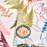 Close-up of the embroidered Cold Beer Clothing Co. logo patch on the left sleeve of the Vintage Big Leaf Button Down, featuring a colorful tropical leaf print.